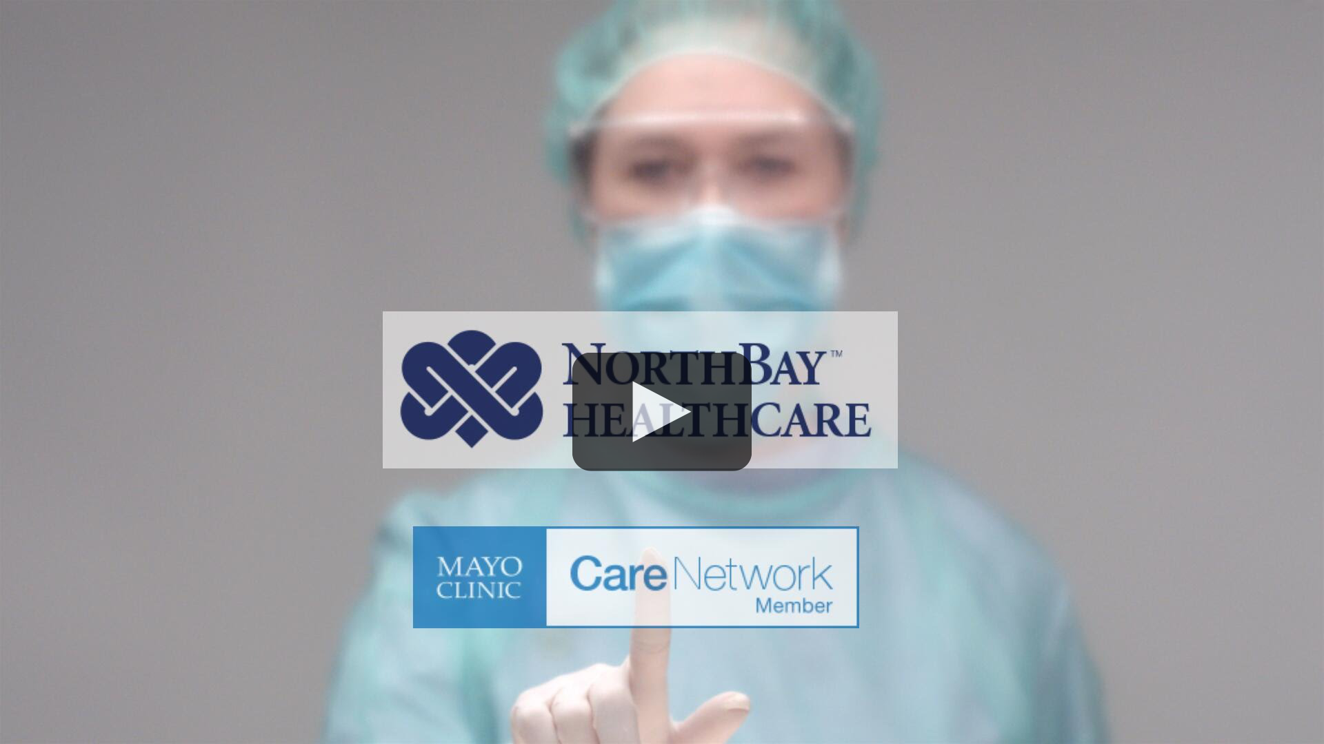 Image of a female surgeon pressing her finger to the screen where both the Mayo Clinic Care Network and NorthBay Healthcare logos are shown.