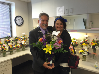 Dr. J.D. Lopez accepts a special bouquet of flowers from Debbie Sexauer at the Cancer Center.