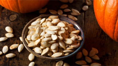 A bowl of roasted pumpkin seeds.