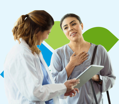 A doctor interacting with a patient. The doctor is turned away, holding a clipboard up to their patient who's face is bright with relief.