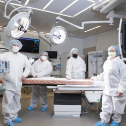 Members of our Heart & Vascular team dressed up in surgical garb, showing off our newly renovated catheterization lab.