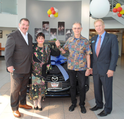 Tracy Mitchell of Wise Auto Group and Jubilee Committee Chair Craig Bryan, hand the keys to Terryl Buntrock and Dr. Wayne Walker.