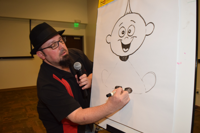 Adam Burke illustrates Jack-Jack, a character from The Incredibles, during a NorthBay management team meeting in December 2017.