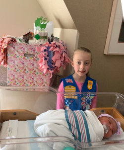 Daisy Hannah Hanes of Troop 30088 in Fairfield poses with baby “Treasure,” who was born just hours after the Girl Scouts official birthday of March 12.