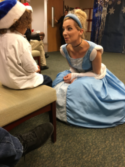 Marcelo Emerson, who donated his birthday presents for the Center for Women's Health party chats with Cinderella.