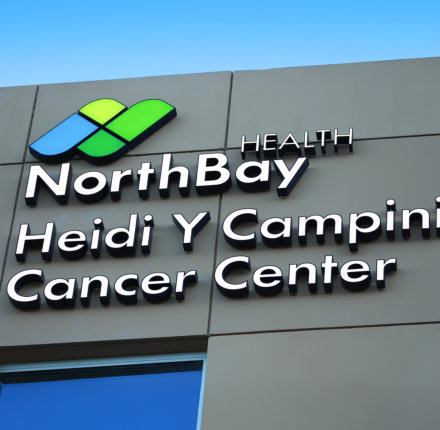 Close up of the new building signage starting with NorthBay Health's logo with the Heidi Y Campini Cancer Center name underneath.